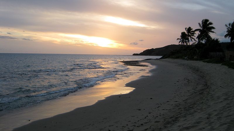 The beach at Taunovo Bay at sunset